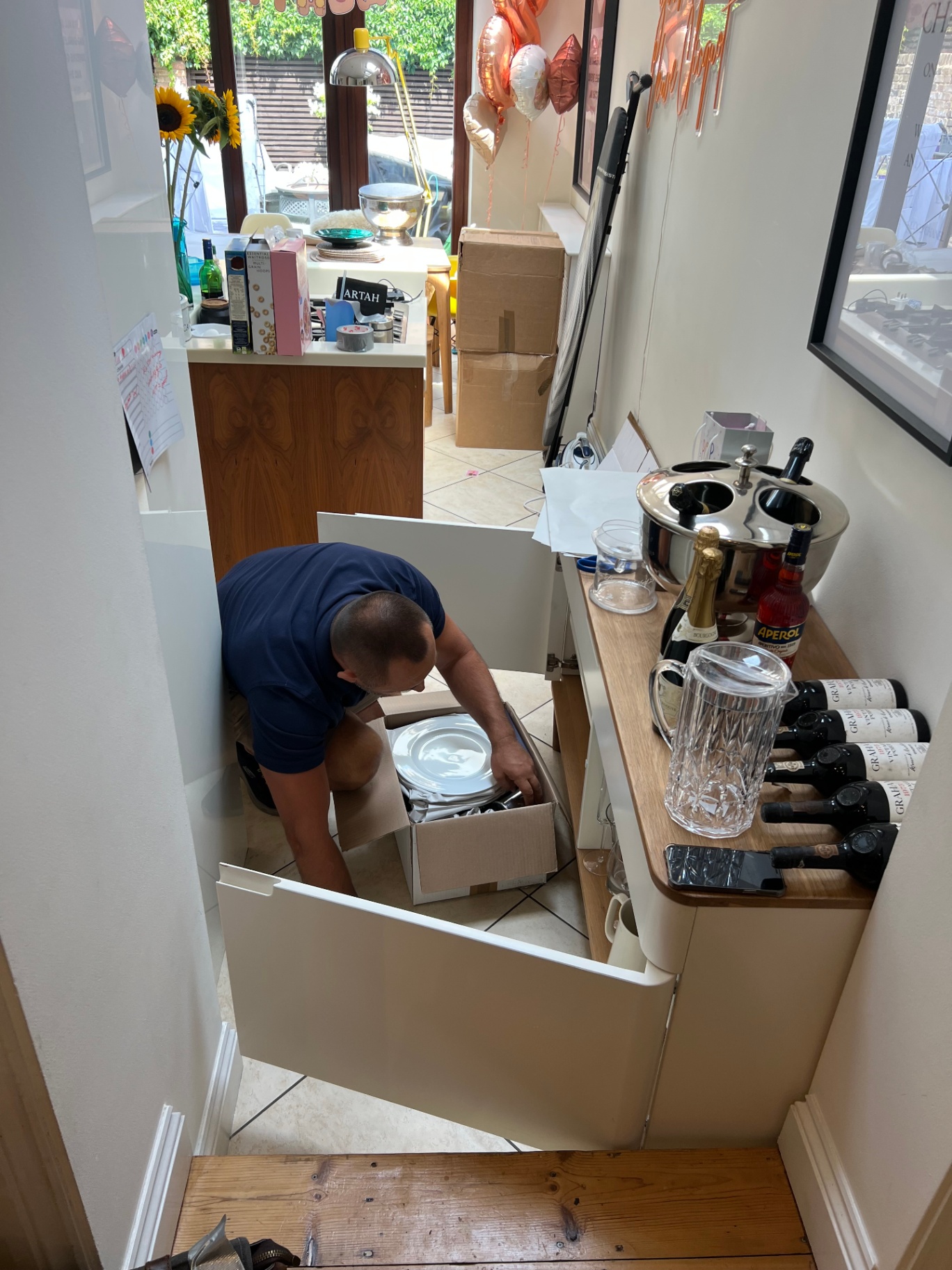 Dimond Movers packer stacking plates into a box with protective paper