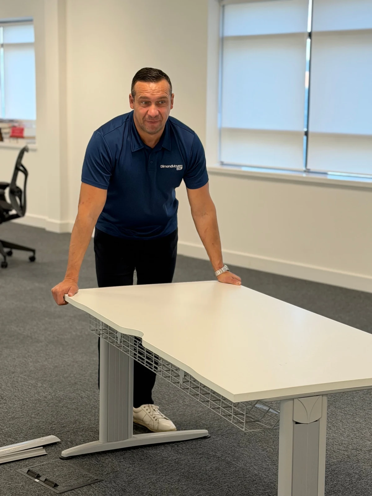 Dimond Movers team member handling an office desk for Walter P Moore