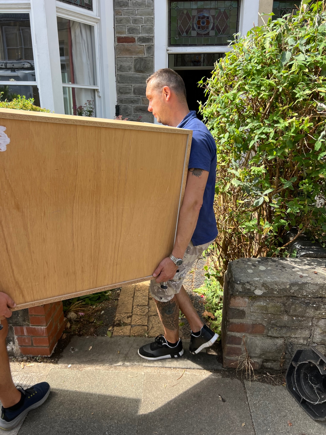 Dimond Movers crew member carrying a wardrobe panel out of a Bristol Victorian home
